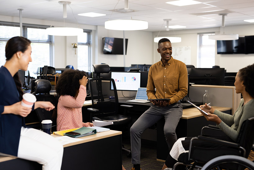 Diverse team members in office laughing